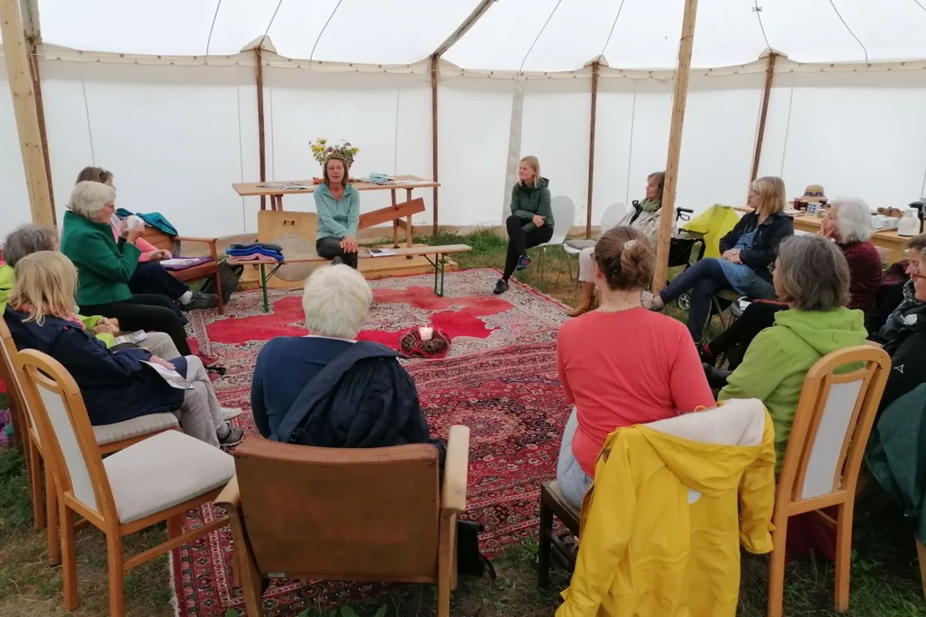 Frauen sitzen auf Stühlen im Kreis