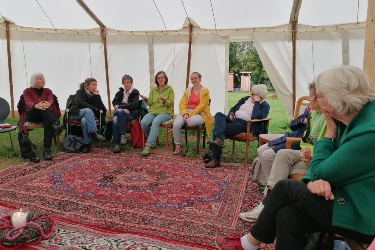 Frauen sitzen auf Stühlen im Kreis 